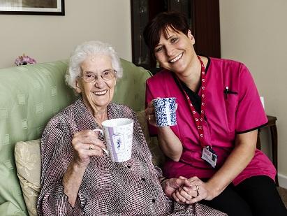 Carer Sally Rutty (on the right) providing care in the home