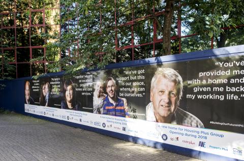 The posters are shown on the hoardings outside Reynolds House